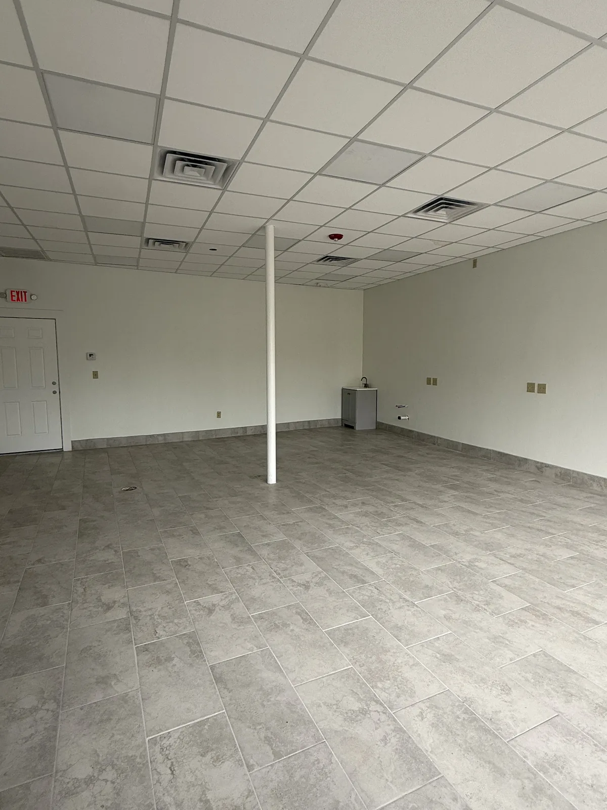 Unit 3, right side of the room, with the door to the rear hallway and the center support post
